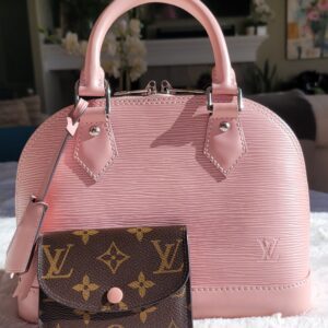 Louis Vuitton Pink Epi Alma BB on a table